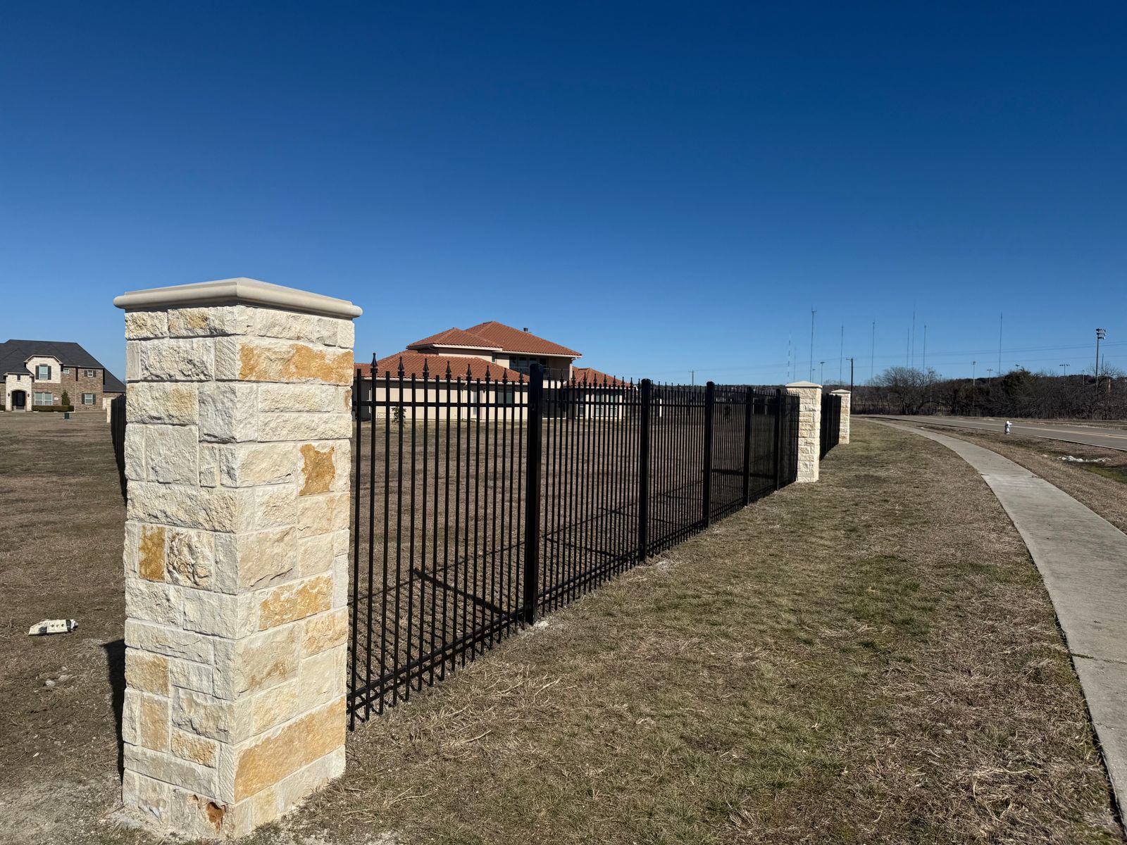 Custom wood fence with decorative top rail on a DFW residential property