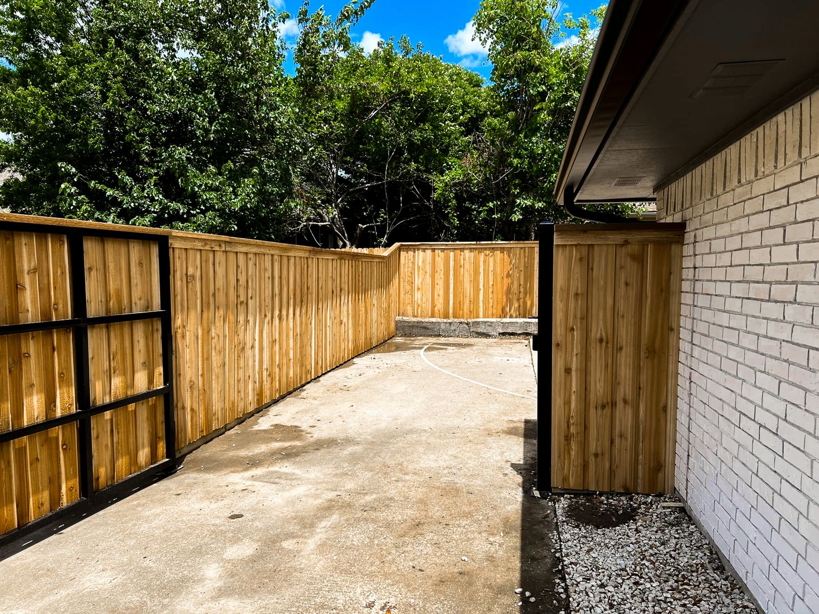 Custom wood driveway gate built in-house for a Fort Worth, TX home