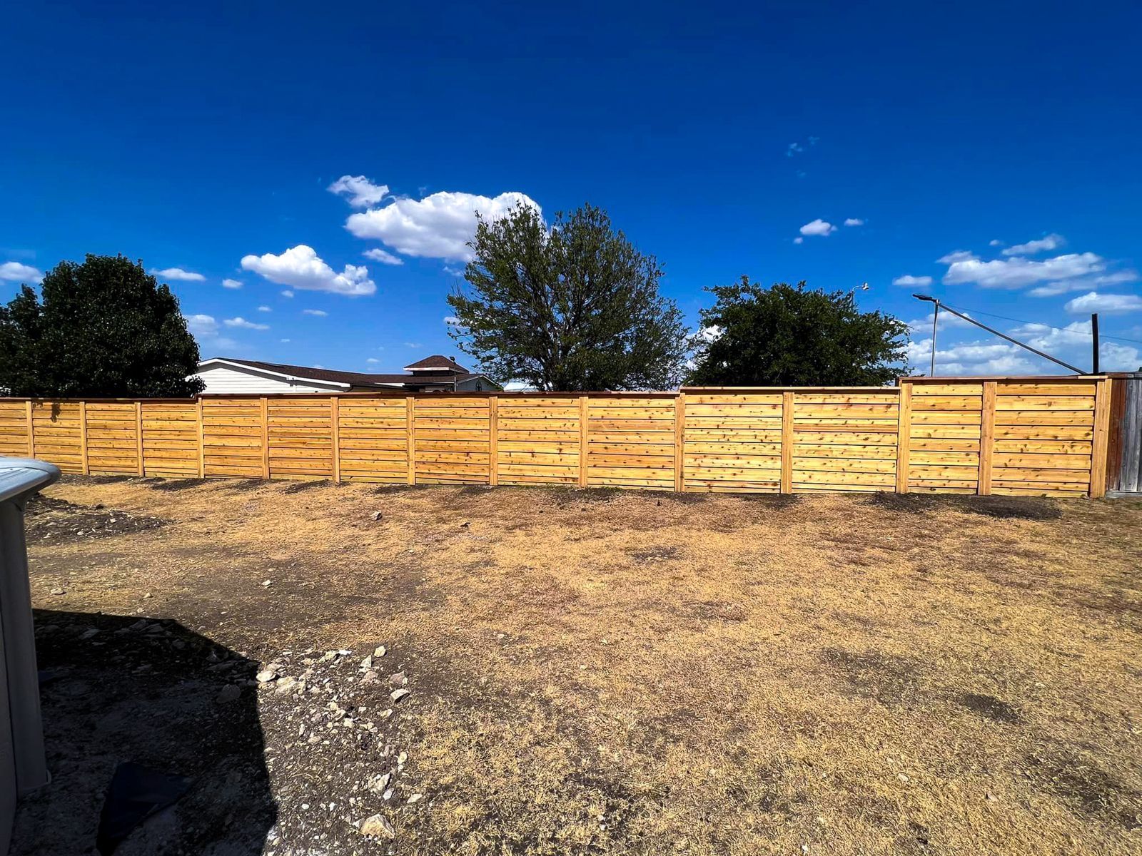 Residential wood fence installation in a Fort Worth, TX backyard